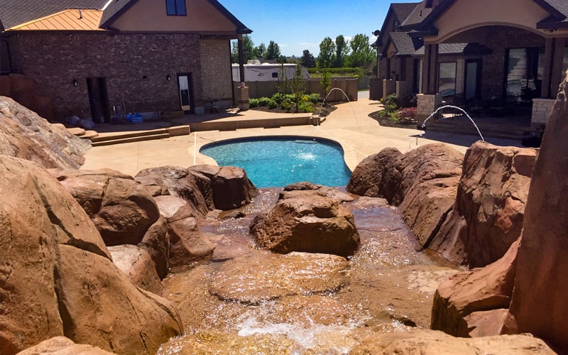 Utah Pool Builder | Custom in-ground swimming pool with waterfall landscaping in Utah | SLC hardscaping contractor | SBI Waterfalls | Stevenson Brothers Custom Pools