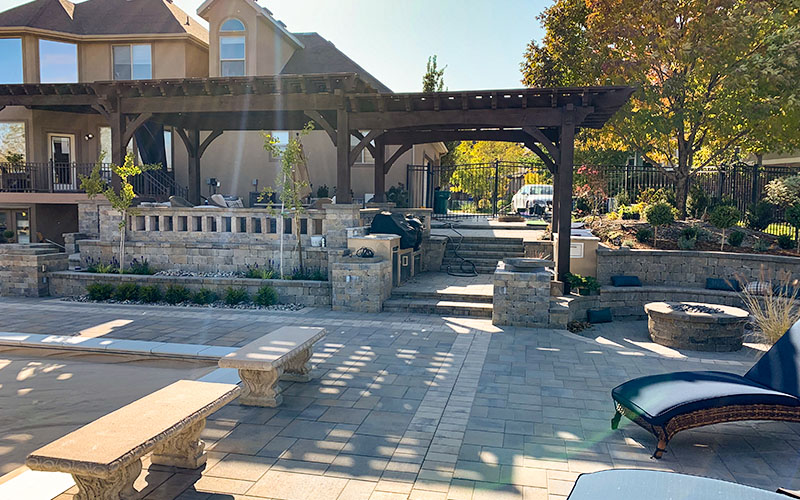 Utah custom backyard landscaping with fire pit and pavers