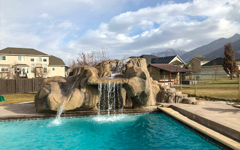 Resort-Style Backyard Custom Pools with Rock Waterfalls & Slide in Salt Lake City, UT | Utah Custom Pool Builder | Stevenson Brothers Custom Pools