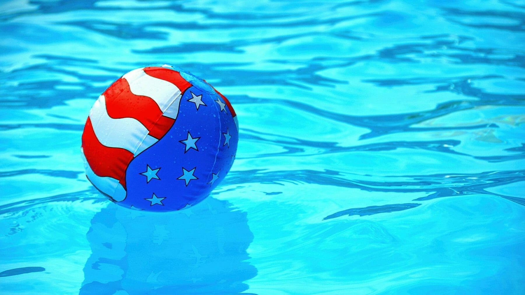 Patriotic pool party with American flag beach ball.
