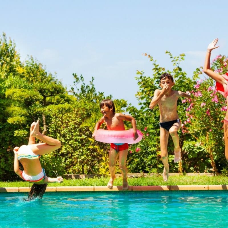 Kids jumping into custom swimming pool in Utah