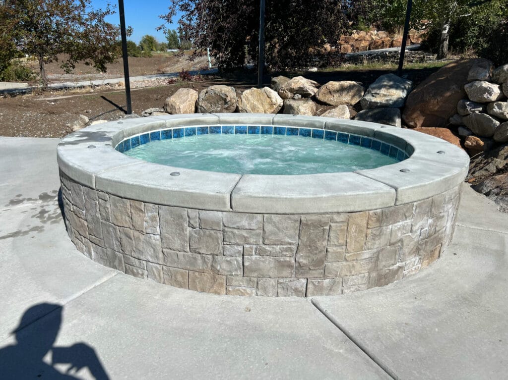 Custom round hot tub spa design in Salt Lake City, Utah backyard - Stevenson Brothers Custom Pools